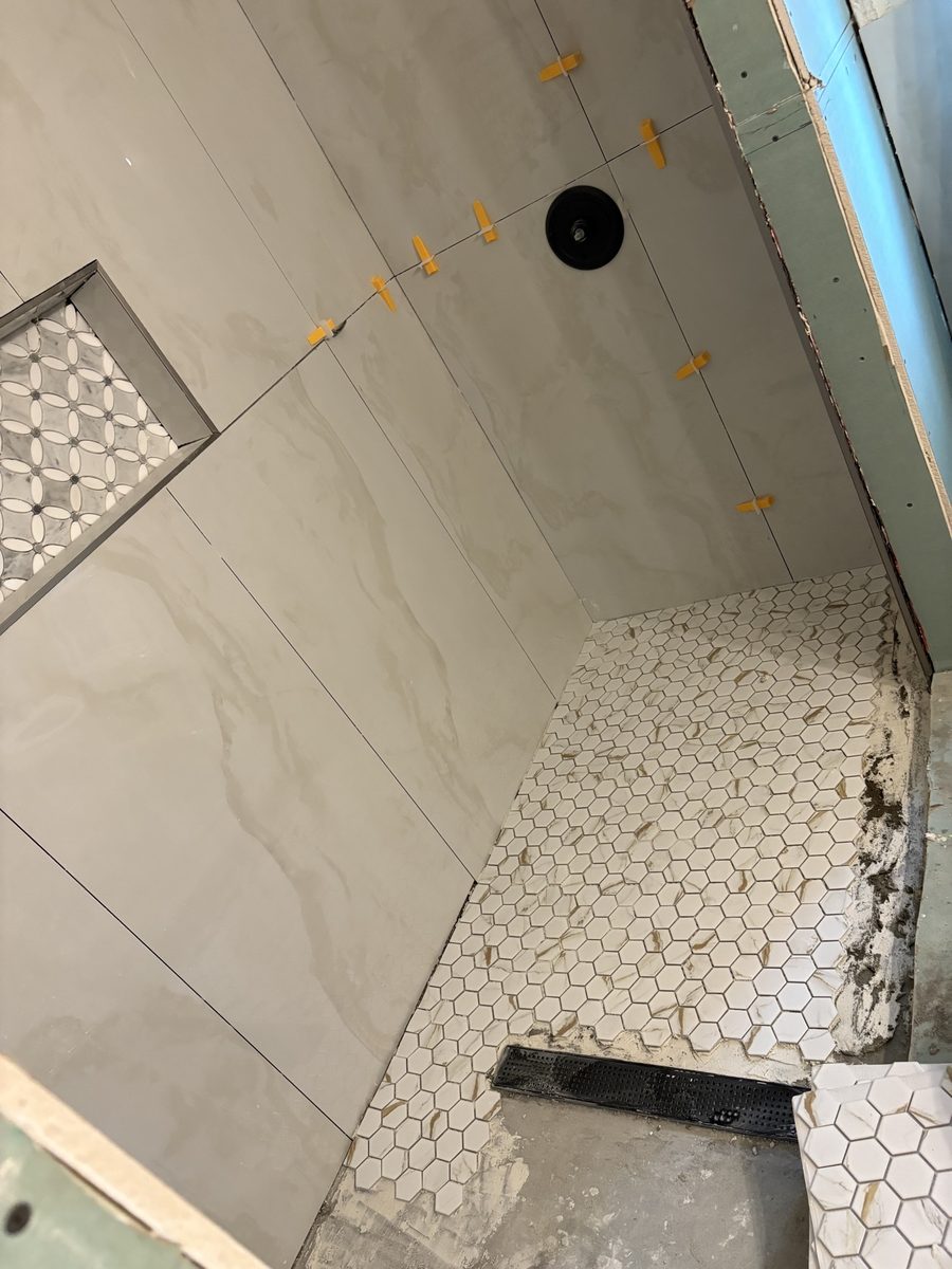 Shower with hex mosaic pan and mosaic niche