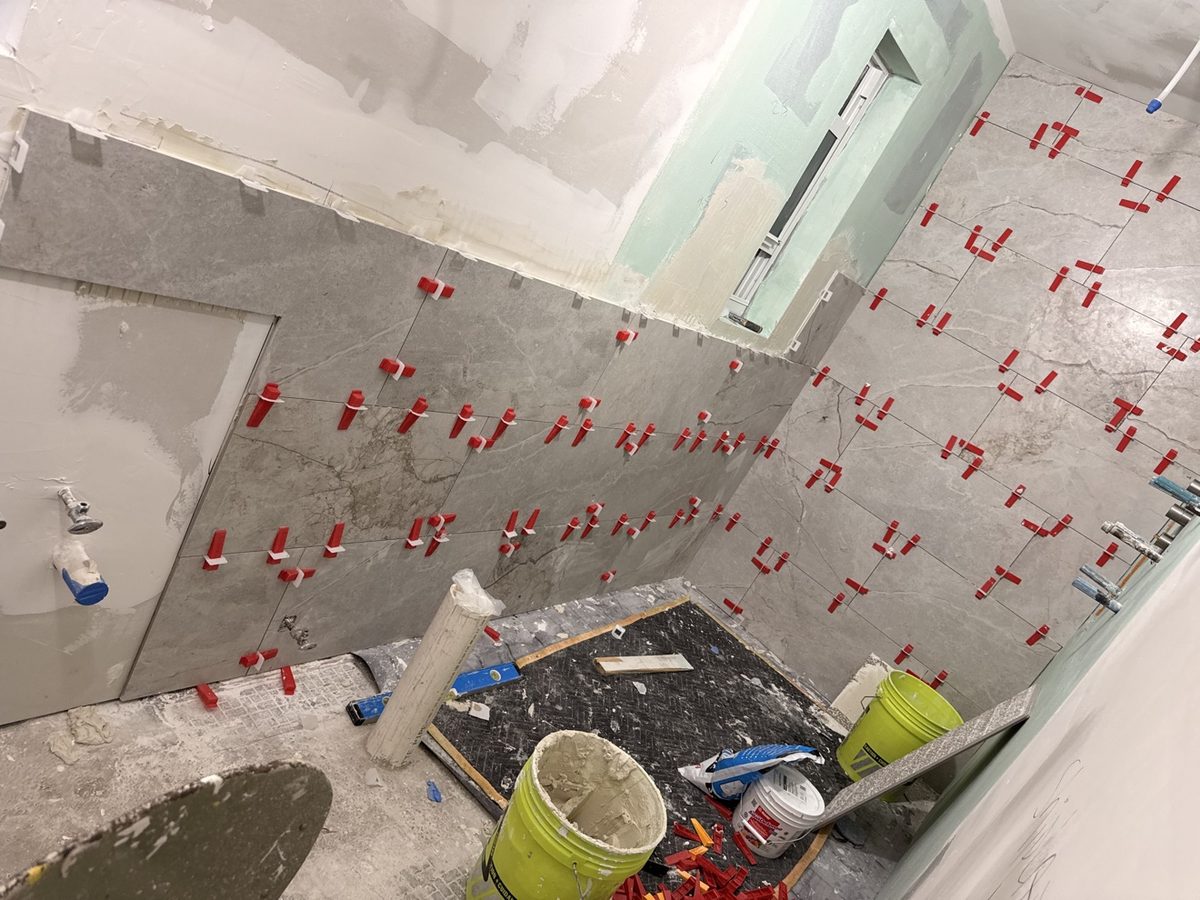 Bathroom tile installation in progress