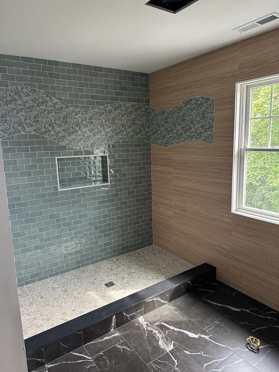 Walk-in shower with wave accent tile