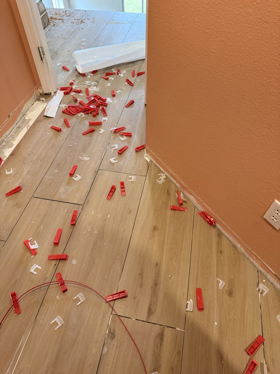 Tile floor installation with spacers