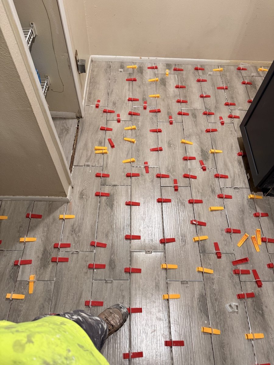 Wood-look tile floor install in progress