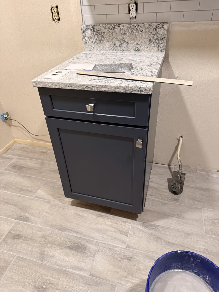 Navy kitchen cabinets with granite countertop