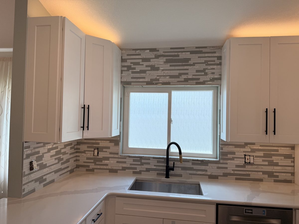 Kitchen sink and mosaic backsplash